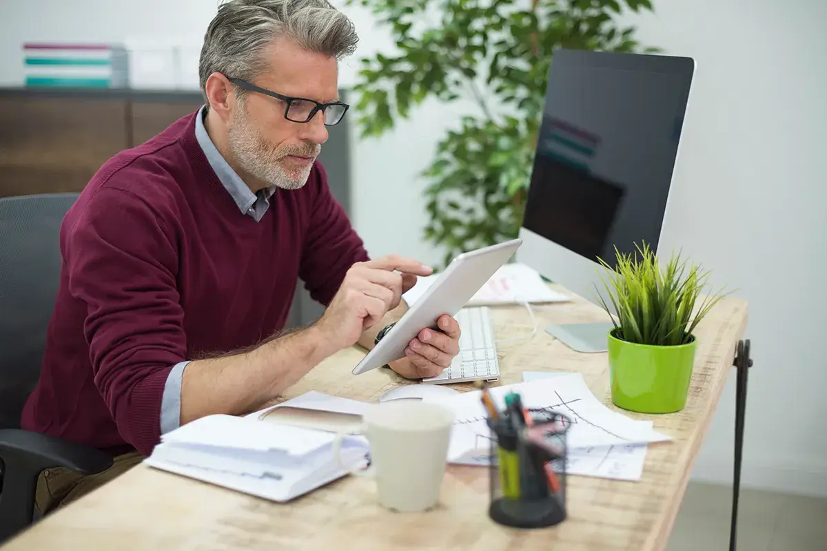 small business owner calculating profit using spreadsheet