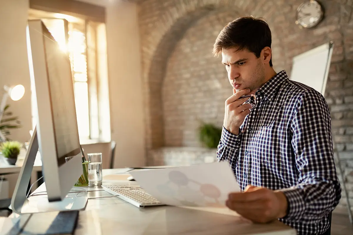 Small business owner reviewing a potential cash flow shortage